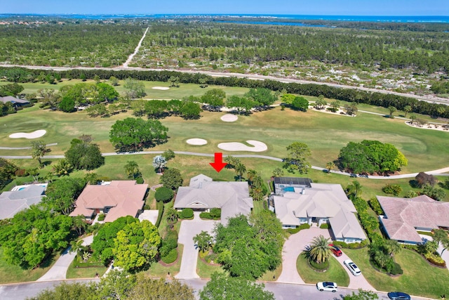 bird's eye view featuring view of golf course, a forest view, and a residential view