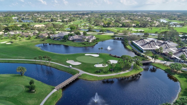 aerial view featuring golf course view and a water view