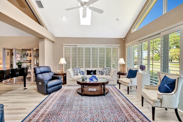 living room featuring visible vents, wood finished floors, high vaulted ceiling, and ceiling fan