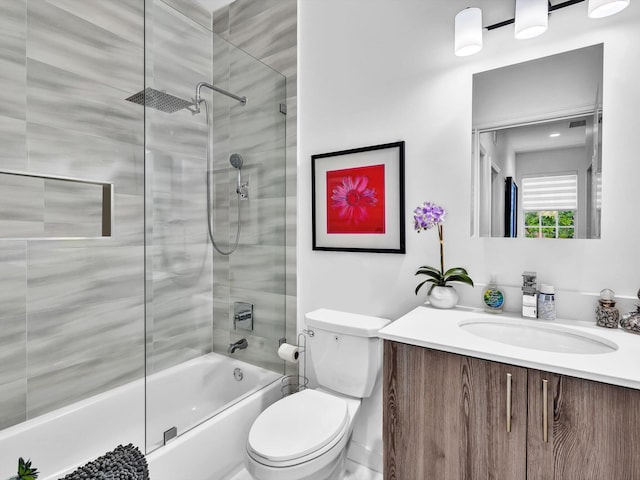 bathroom featuring vanity, toilet, and combined bath / shower with glass door