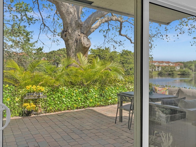 view of patio featuring outdoor dining space and a water view