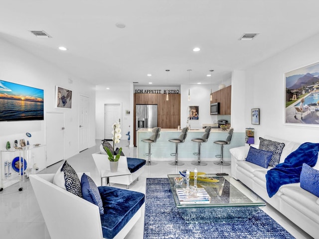 living room featuring visible vents and recessed lighting