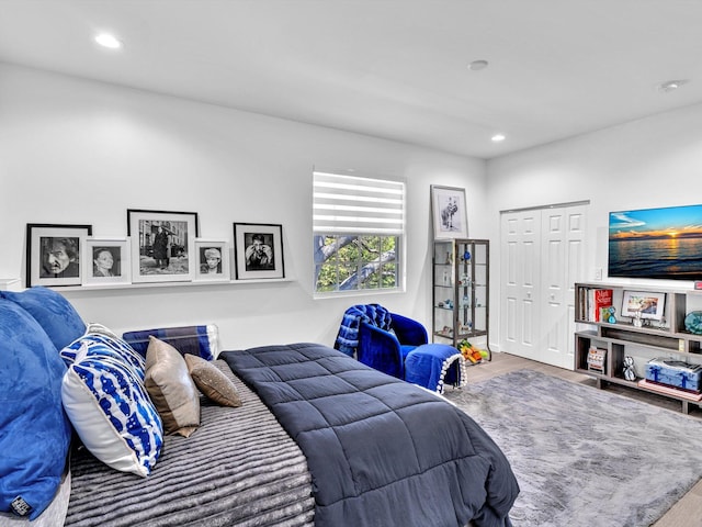 bedroom featuring a closet, recessed lighting, and wood finished floors