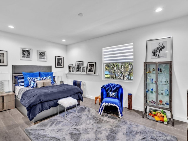 bedroom featuring recessed lighting, baseboards, and wood finished floors