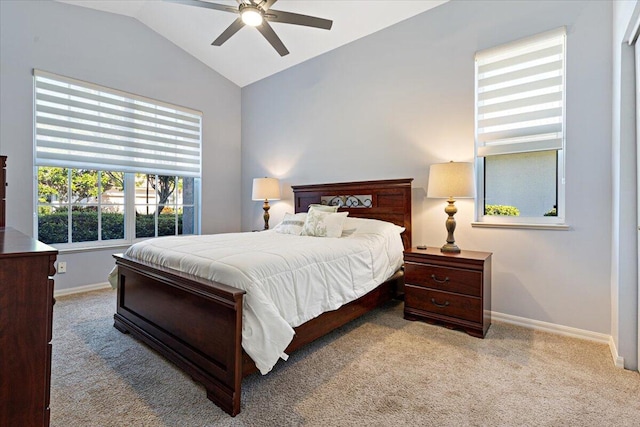 carpeted bedroom featuring ceiling fan, baseboards, and lofted ceiling