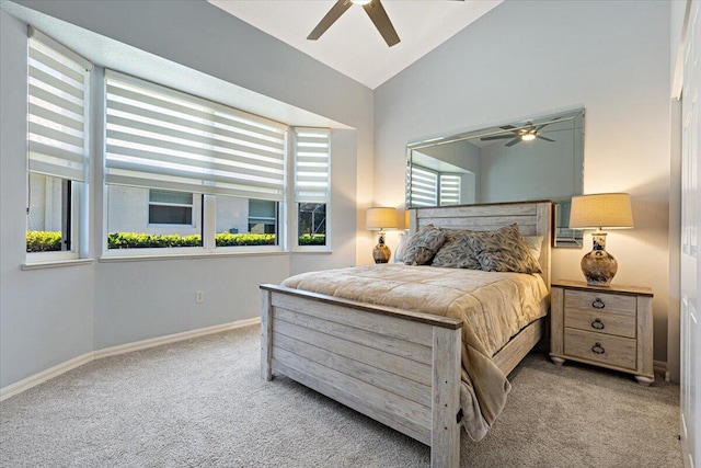 carpeted bedroom with baseboards, lofted ceiling, and a ceiling fan