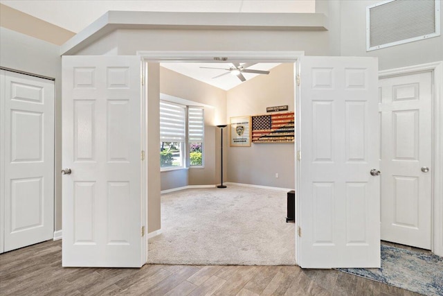 unfurnished bedroom with visible vents, wood finished floors, baseboards, and vaulted ceiling