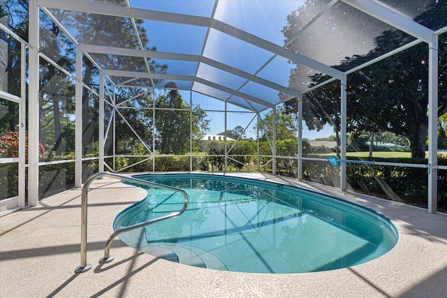 pool with a patio area and glass enclosure