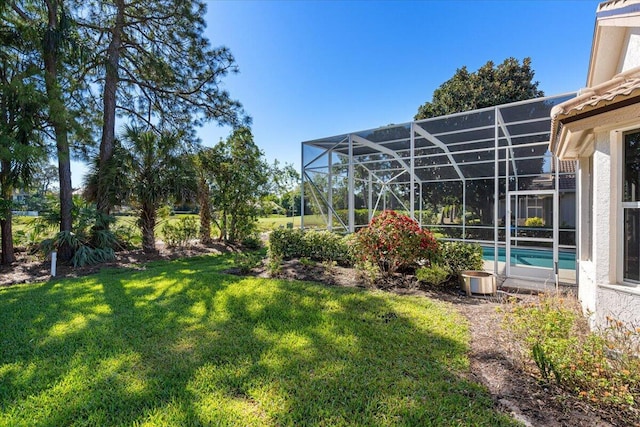 view of yard with an outdoor pool and glass enclosure