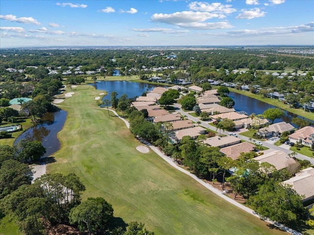 drone / aerial view featuring a residential view, a water view, and golf course view