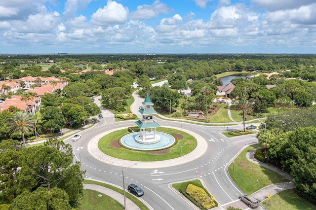 birds eye view of property with a view of trees and a water view