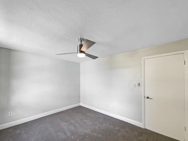 unfurnished room featuring dark carpet, a textured ceiling, baseboards, and ceiling fan