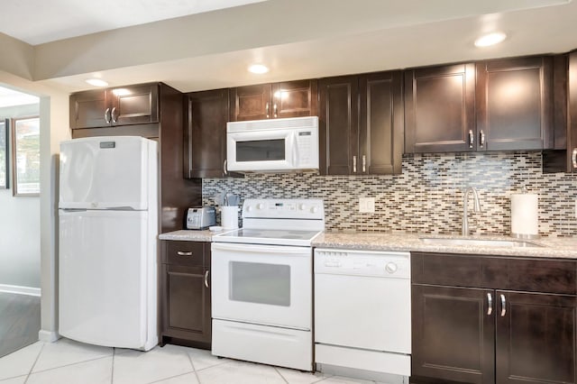 5801 Camino Del Sol Unit 102, Boca Raton, FL 33433 - kitchen featuring decorative backsplash, dark brown cabinets, white appliances, and a sink