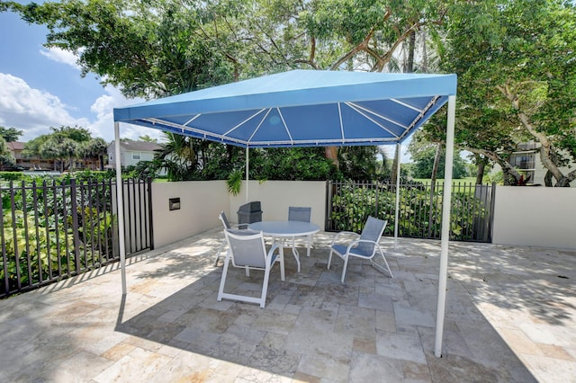 5801 Camino Del Sol Unit 102, Boca Raton, FL 33433 - view of patio / terrace with a gazebo, outdoor dining area, and fence