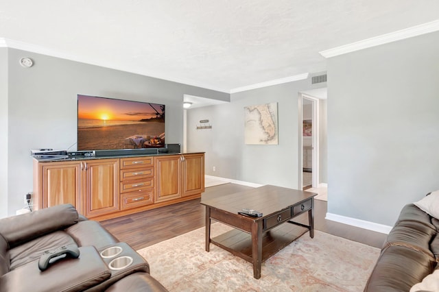 5801 Camino Del Sol Unit 102, Boca Raton, FL 33433 - living room featuring visible vents, baseboards, light wood-style flooring, and ornamental molding