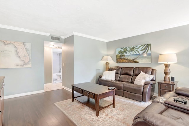 5801 Camino Del Sol Unit 102, Boca Raton, FL 33433 - living area featuring visible vents, crown molding, baseboards, and wood finished floors