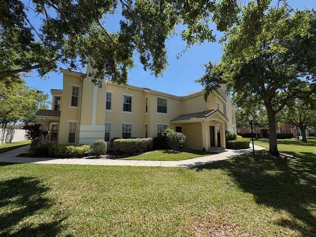 view of front of home with a front lawn and stucco siding