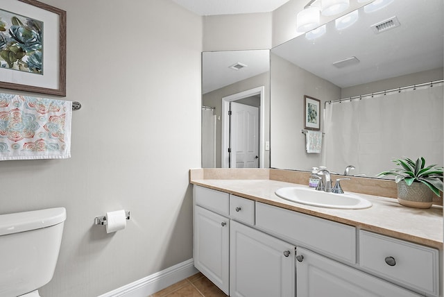 bathroom with vanity, baseboards, visible vents, tile patterned flooring, and toilet