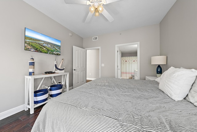 bedroom with visible vents, ensuite bathroom, dark wood finished floors, baseboards, and ceiling fan