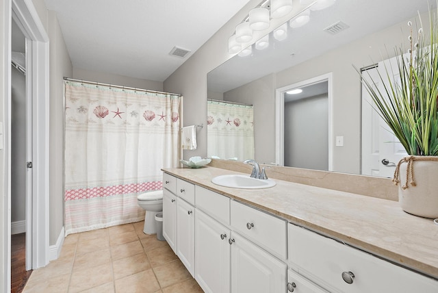 bathroom featuring vanity, tile patterned floors, toilet, and visible vents