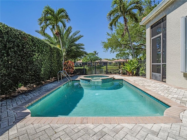 view of pool featuring a pool with connected hot tub, a patio, and fence