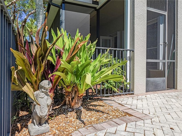 exterior space featuring stucco siding and fence