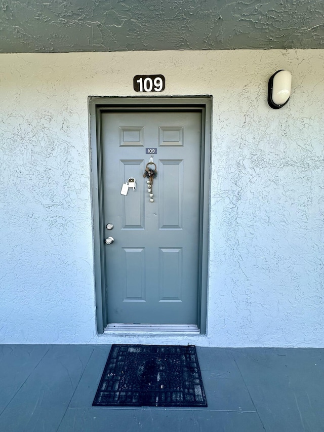 doorway to property with stucco siding