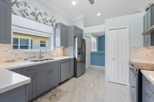 kitchen featuring ornamental molding, gray cabinets, marble finish floor, stainless steel appliances, and a sink