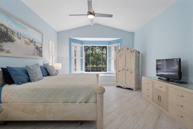 bedroom featuring lofted ceiling, light wood-style floors, and a ceiling fan