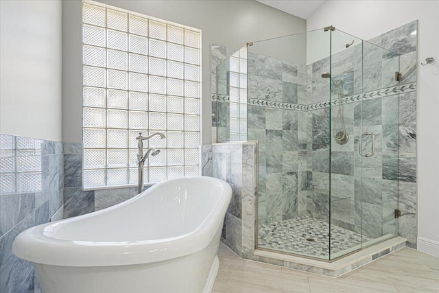 bathroom with a soaking tub and a stall shower