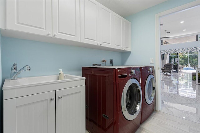 clothes washing area featuring a ceiling fan, recessed lighting, cabinet space, a sink, and washer and clothes dryer