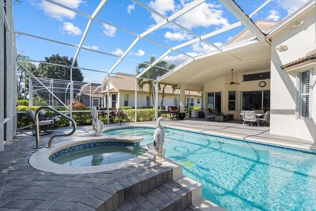 view of pool featuring a pool with connected hot tub, a lanai, and a patio area