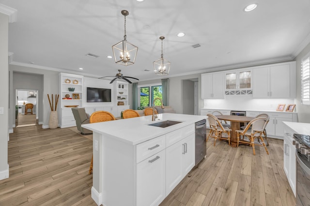 kitchen with visible vents, stainless steel appliances, a sink, light countertops, and crown molding