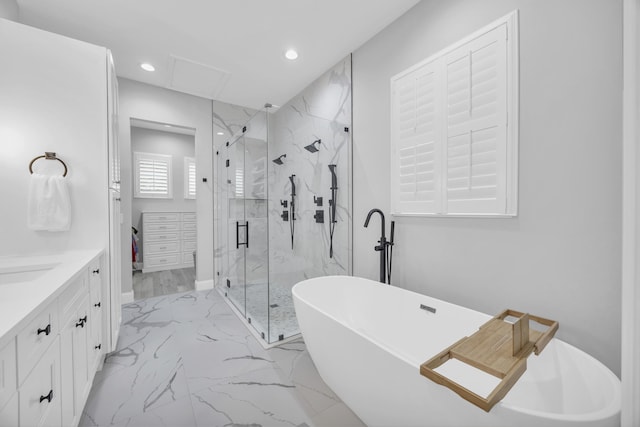 bathroom featuring a marble finish shower, recessed lighting, a freestanding tub, marble finish floor, and vanity