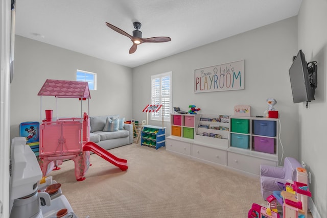 rec room with carpet floors, a healthy amount of sunlight, and ceiling fan