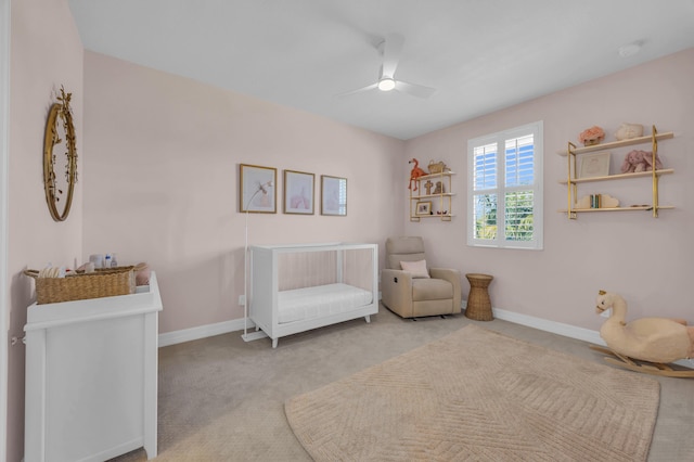 sitting room featuring baseboards, carpet, and ceiling fan