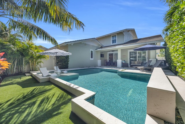 view of pool featuring a yard, fence, a fenced in pool, and a patio area