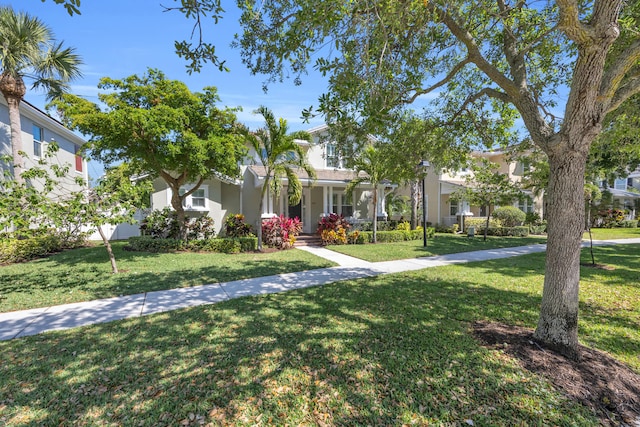 view of front of house featuring stucco siding and a front yard