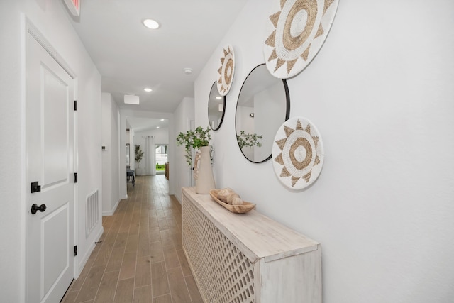 hallway featuring recessed lighting, visible vents, and light wood-type flooring