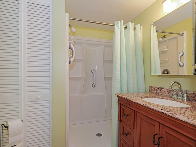 bathroom featuring a shower stall and vanity