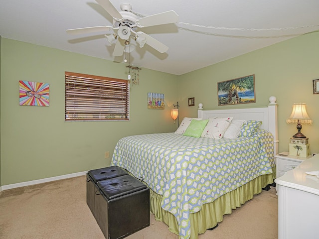 bedroom with baseboards, light carpet, and ceiling fan