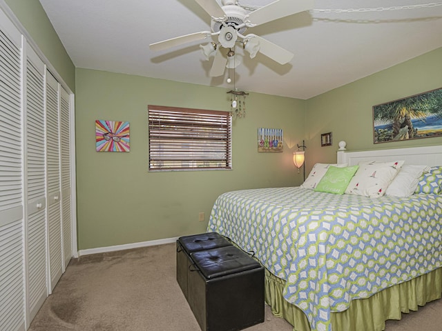 carpeted bedroom featuring baseboards, a closet, and ceiling fan