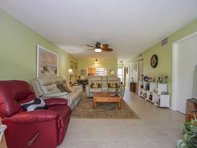 living area featuring light tile patterned floors, visible vents, and ceiling fan