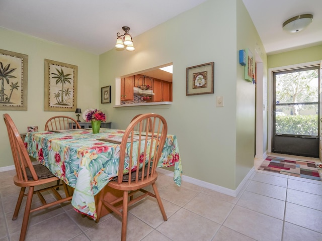 dining area featuring light tile patterned floors and baseboards