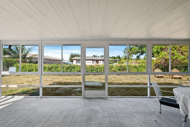 unfurnished sunroom with wooden ceiling