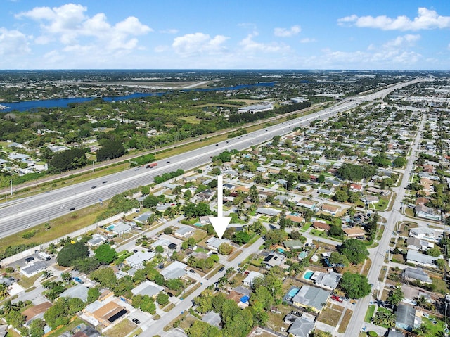 drone / aerial view with a residential view and a water view