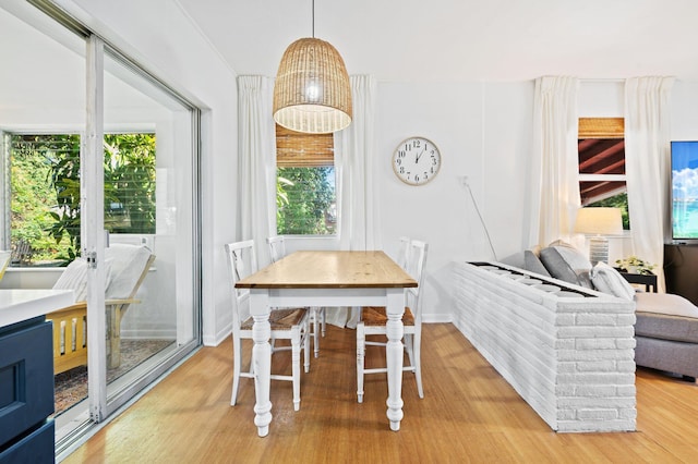 dining area with light wood finished floors and baseboards