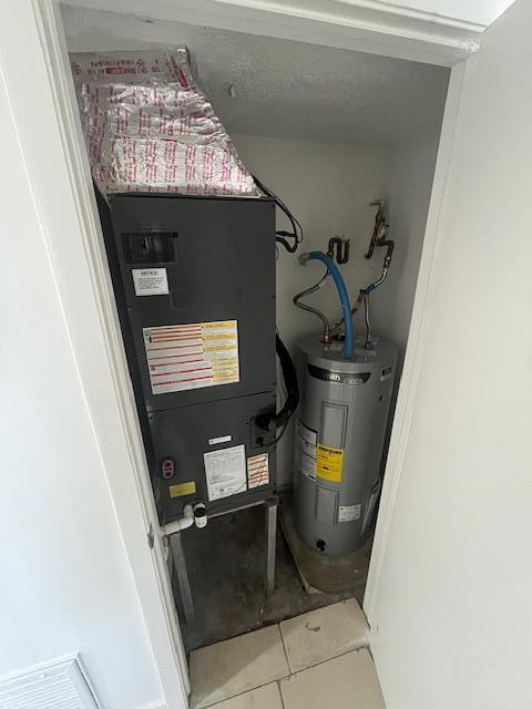 utility room featuring electric water heater