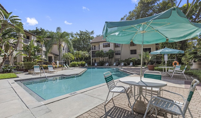 community pool with a patio area