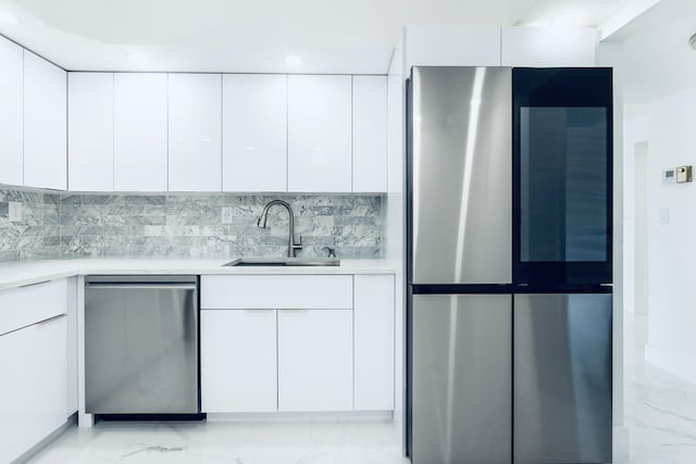 kitchen featuring white cabinets, modern cabinets, appliances with stainless steel finishes, and a sink